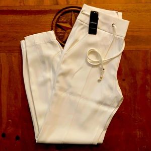 White BEBE relaxed eyelet pants. Originally $119.